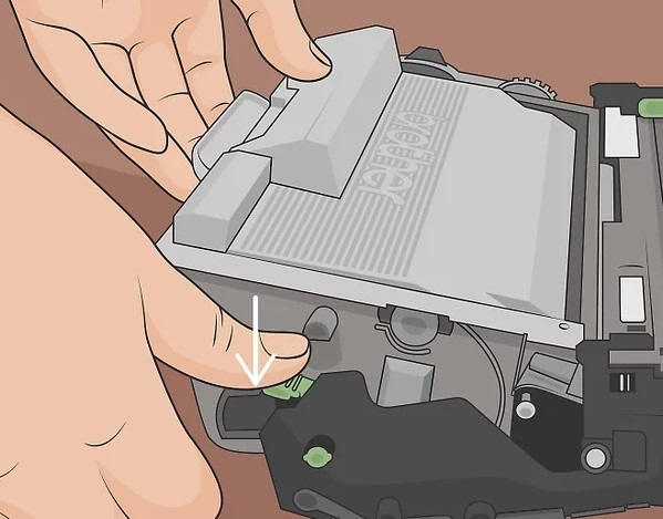 Press the green lever on the drum unit